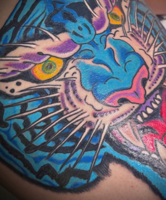 Blue panther head tattoo by Avery Howard